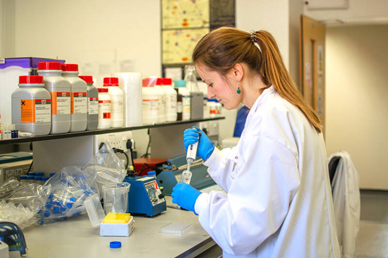 Woman in lab coat working in a l