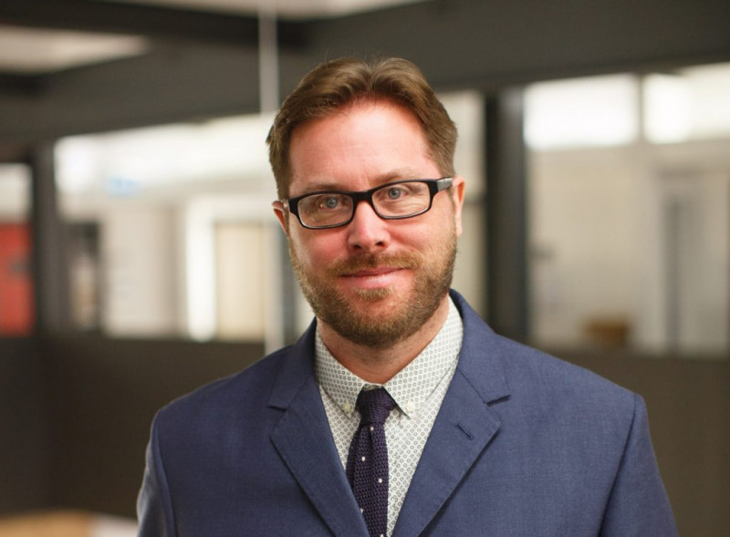 Dr Ben Thomas, glasses, brown hair face to camera