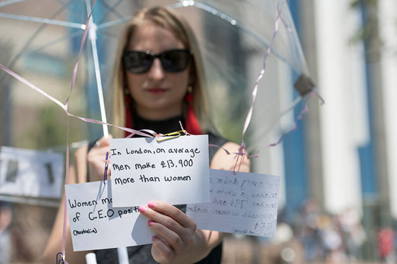 Politics student shows umbrella with political messages attached to it