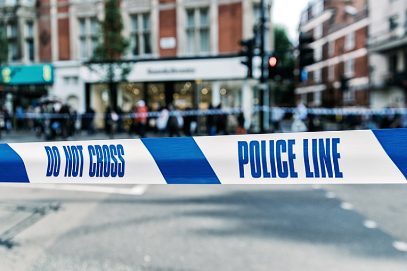 Police tape across a street