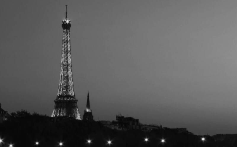 A monochrome image of the Eiffel Tower at night