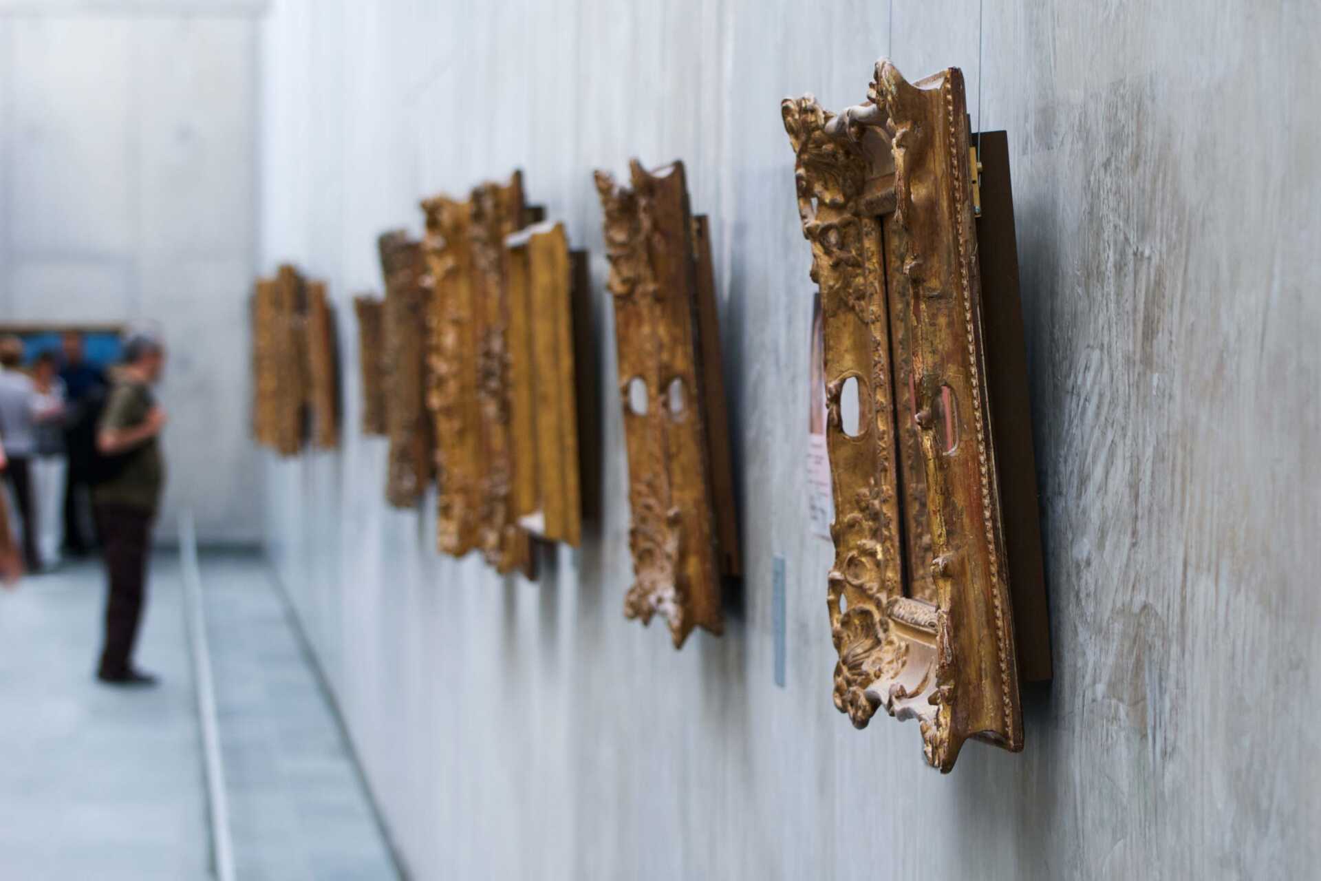 close-up of picture frames hanging in a gallery