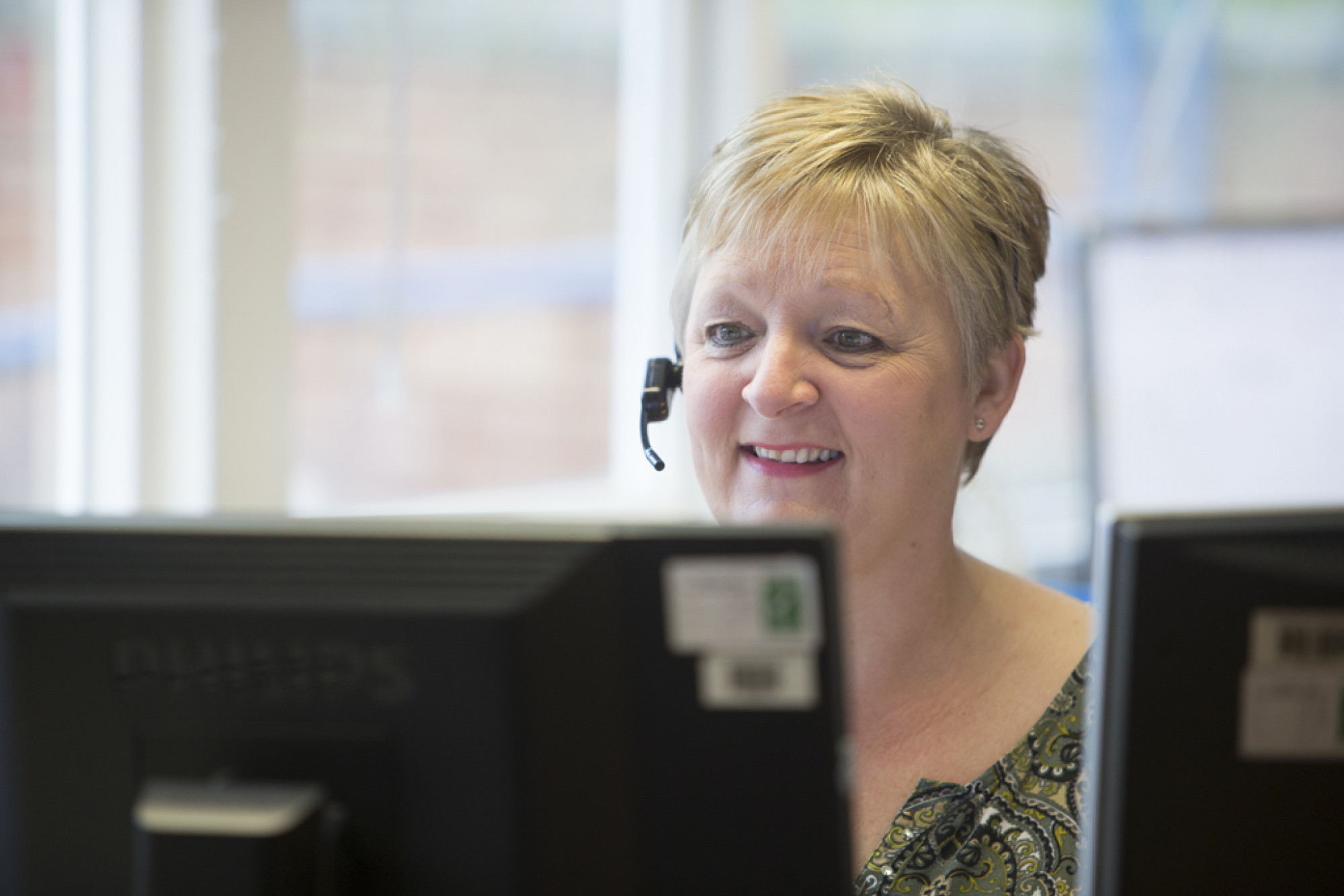 Female speaking through telephone headset.