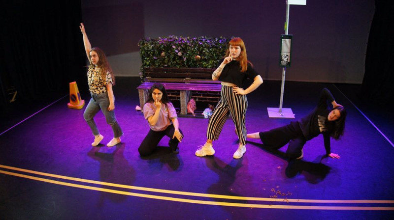 Students performing a dance on stage.