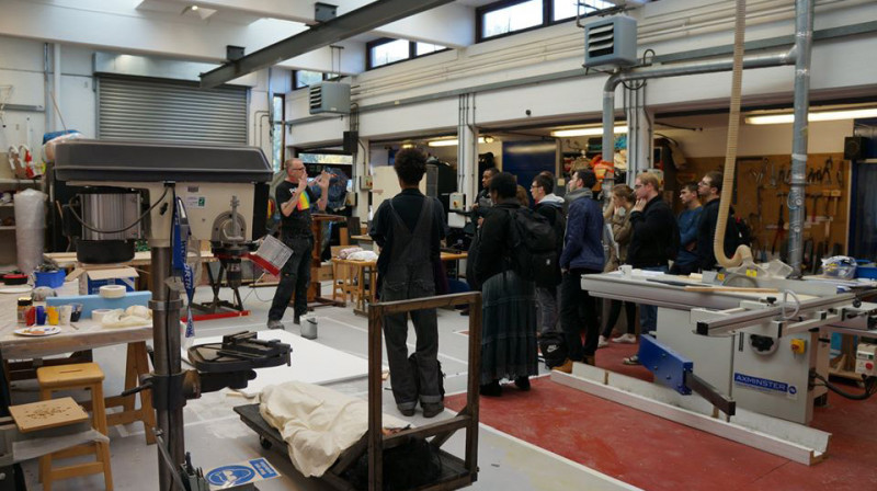 Students in the workshop, with the workshop manager giving an introductory talk.