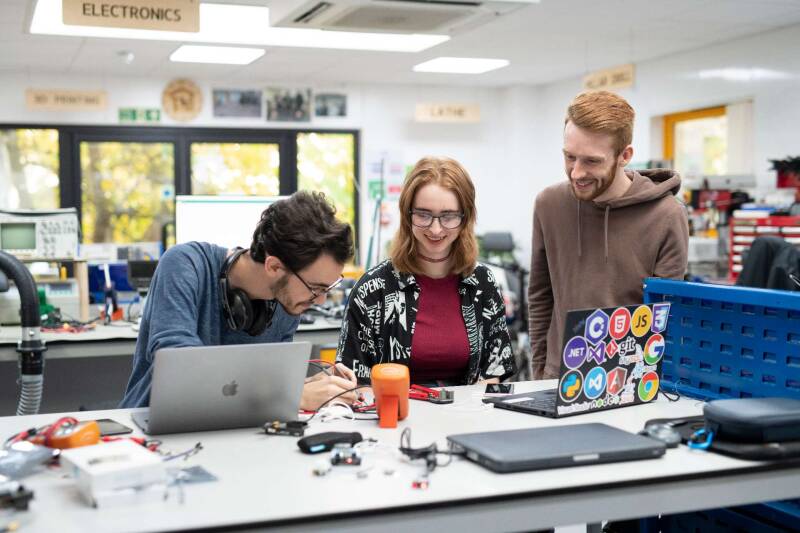 Mixed group of students working with computers