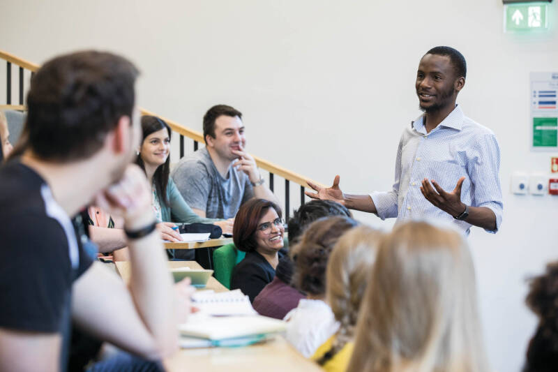 Group of students being taught in a lecture hall