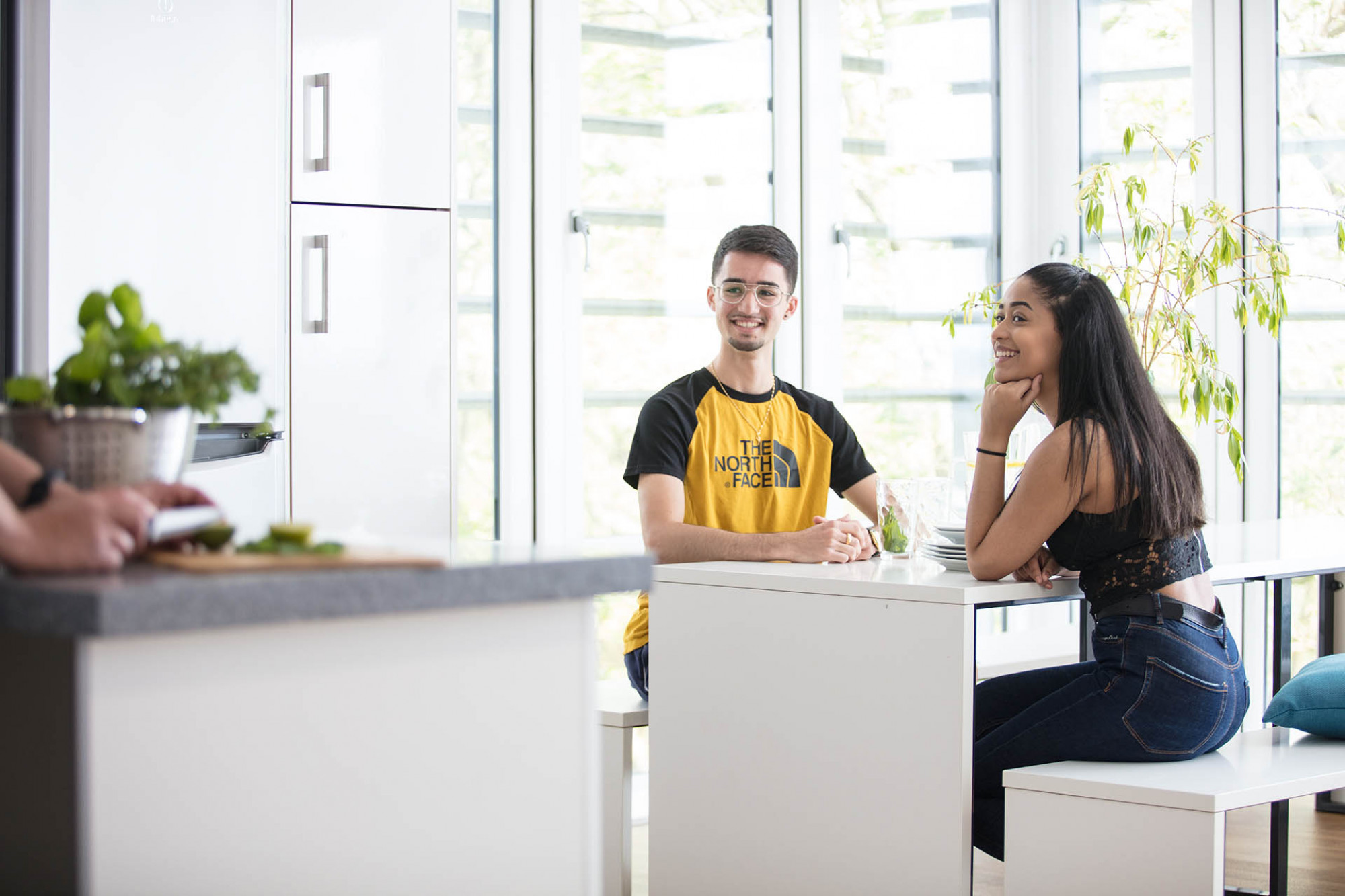 Male and female student talking in a Turing kitchen