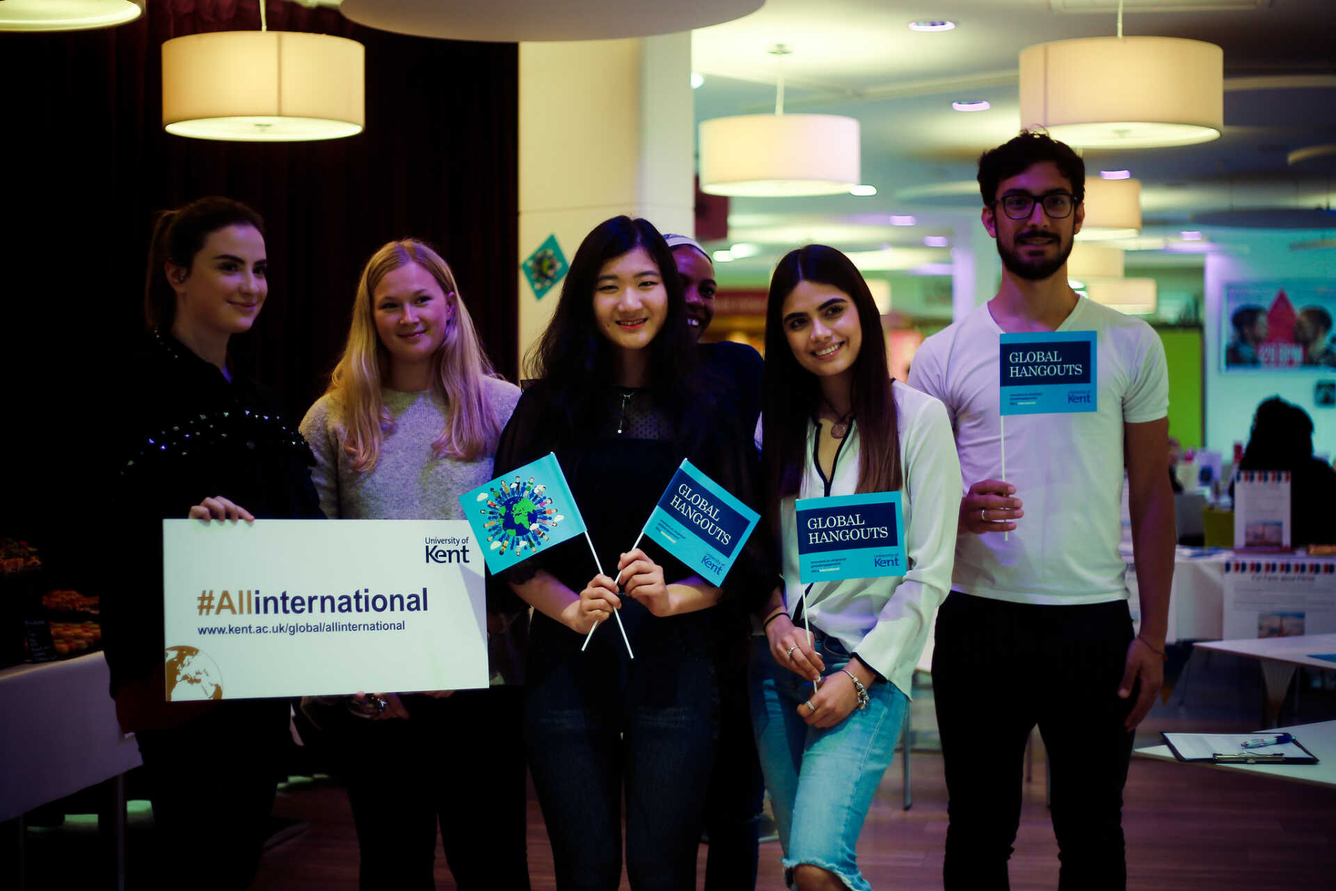 Kent students posing with flags at a Global Hangouts event