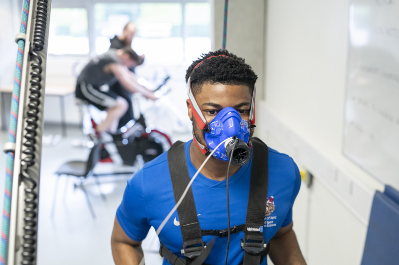 male student on on treadmill with breathing mask on