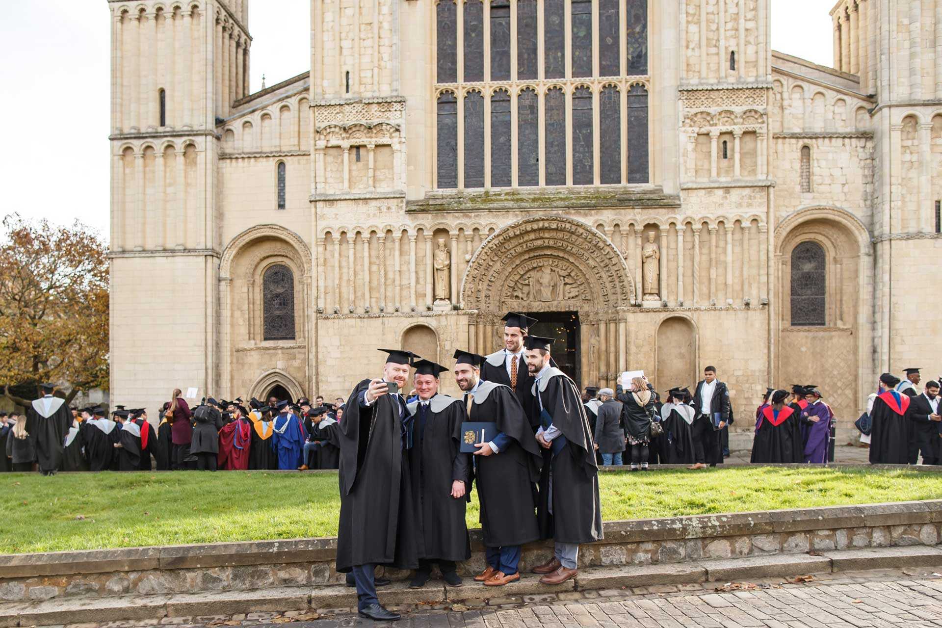 A group of students taking a selfie outside Rochester Cathedral