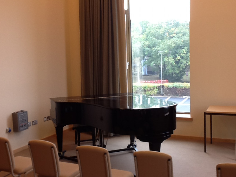 Piano by a window in one of the practice rooms