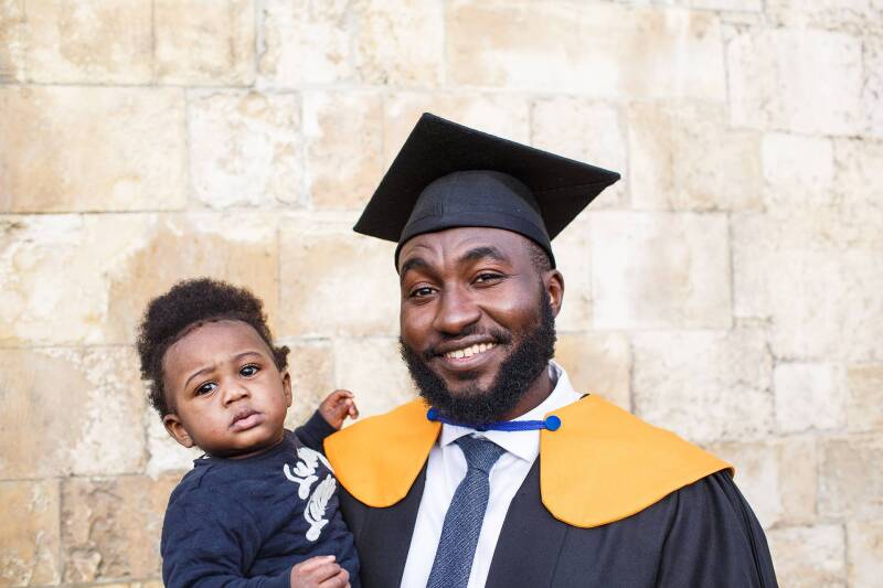 Graduate with his child